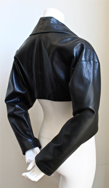 Jet black cropped leather jacket with single button closure from Azzedine Alaia dating to the 1980's. Labeled a French size 36. Length 14