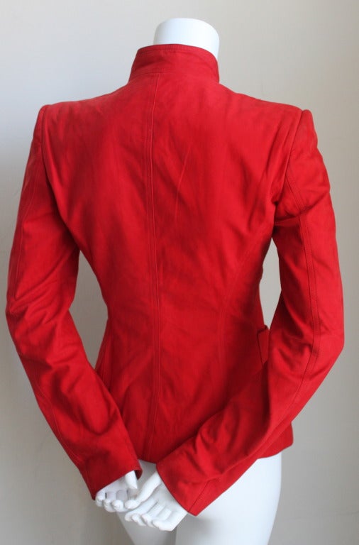 Vivid red nubuck leather jacket with ruffle designed by Tom Ford for Gucci dating to fall of 2003. Labeled a French size 38, although this jacket runs small and best fits a size 2 or 4 (French size 36). Bust measures approximately 34
