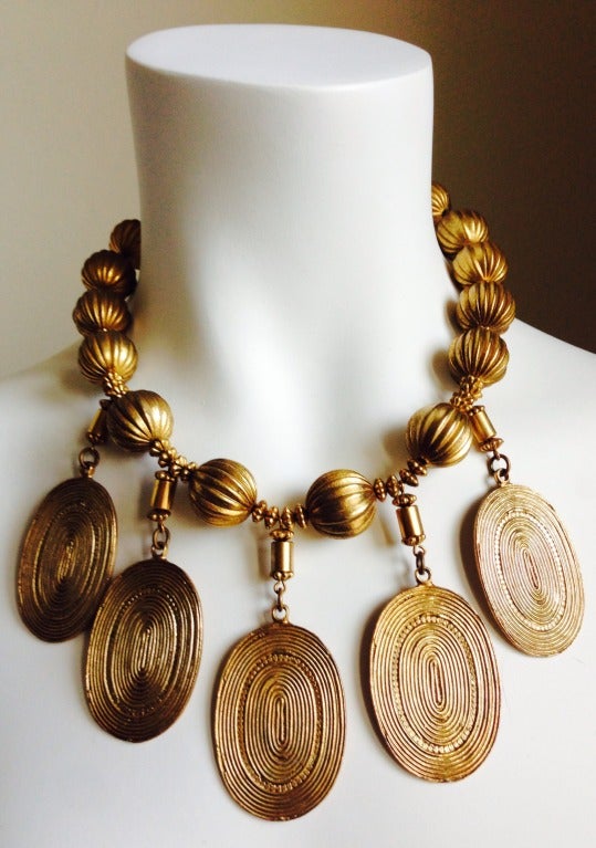 Gilt beaded necklace with medallion pendants from Yves Saint Laurent dating to the 1970's. Necklace measures about 18