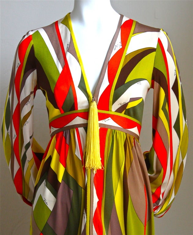 Graphic printed silk jersey dress with large tassel designed by Emilio Pucci dating to the 1960's. Dress is labeled a US size 8, although this dress fits a US 2 or 4. Approximate measurements: shoulders 15.5