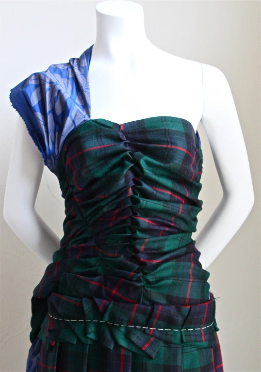 Tartan wool and floral printed cotton dress with rushing and asymmetrical raw hem designed by Comme Des Garcons dating to Fall 2006. Labeled  a Japanese size 'M'. Approximate measurements: bust 34