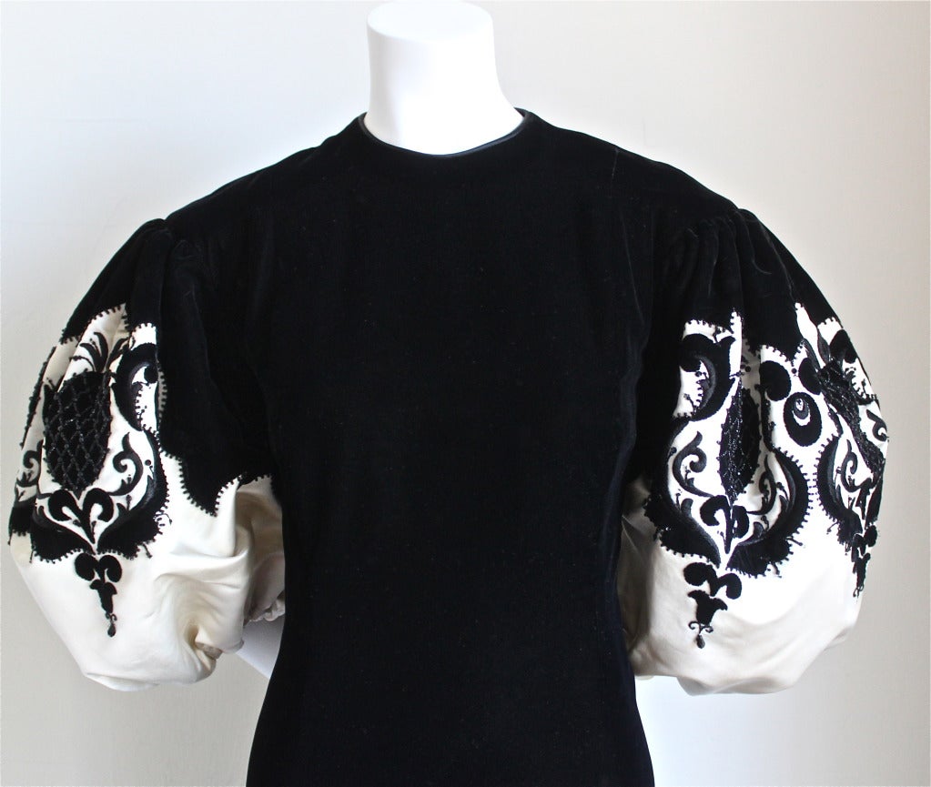 Stunning jet black velvet haute couture gown with large cream satin sleeves decorated with embroidery and beadwork designed by Pierre Balmain dating to the 1960's.  Approximate measurements: shoulder 15, bust 38