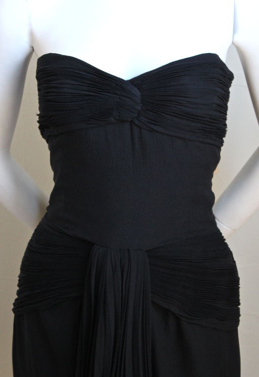 Jet black pleated mini dress from Valentino Boutique dating to the early 1980's. Fits a size 6 or 8. Approximate measurements are: bust 36