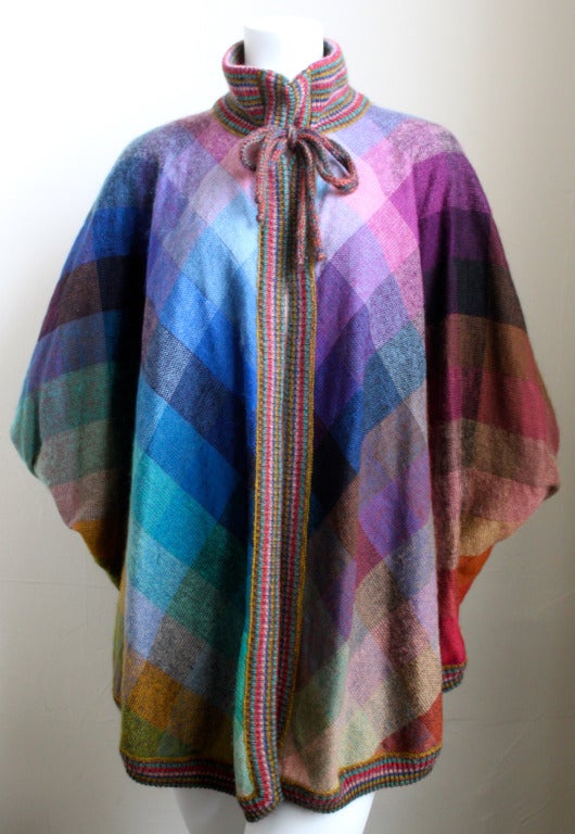 Colorful checked wool poncho with striped trim and reversible lining from Missoni dating to the early 1980's.  Ties at neck.  Fits most sizes due to the open design.  Made in Italy. Excellent condition.