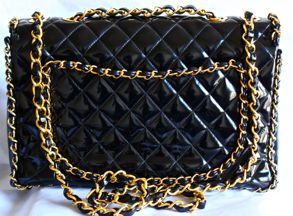 Very rare, jet black patent leatherj maxi bag with chain trim dating to the 1990's. Approximate measurements: Height 10”, Width 14”, Depth 4.5”. Chain (double strap) has a 13