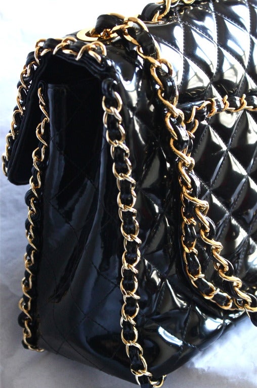 Black very rare vintage CHANEL black patent leather jumbo maxi bag with chain trim
