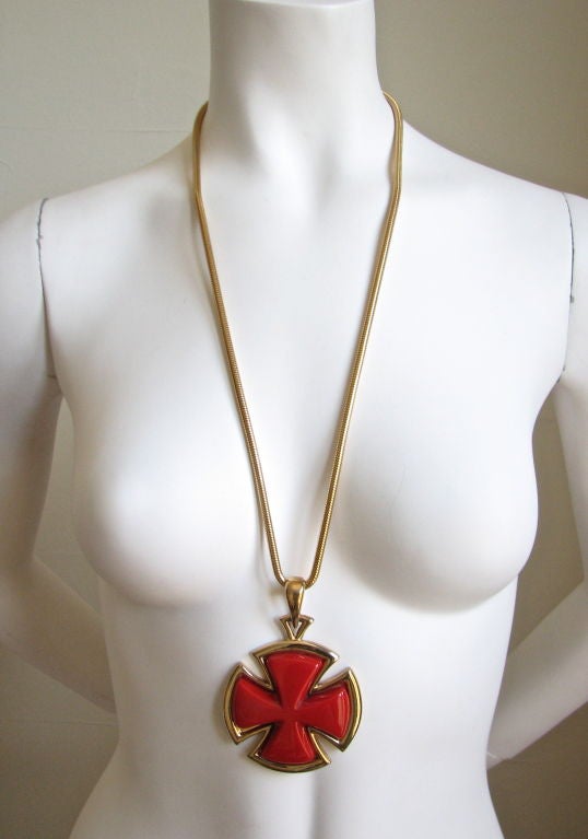 Massive red shiny lucite and gold cross pendant on an extra long slinky snake chain from Lanvin. Measures 4