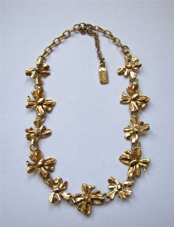 Adorable gilt metal necklace from Yves Saint Laurent with 'bow' motif. Just over 18