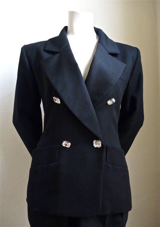 Classic 'le smoking' suit with oversized faceted glass buttons, satin labels, and tuxedo stripe down side of pants from Yves Saint Laurent dating to the 1990's. French size 34. (25