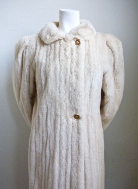 Luxurious ivory mink from Galanos. Ca. 1960. Fits a US 2-6. Full length. Pockets at hips. Fully lined. Very good condition (discolorations to lining).
