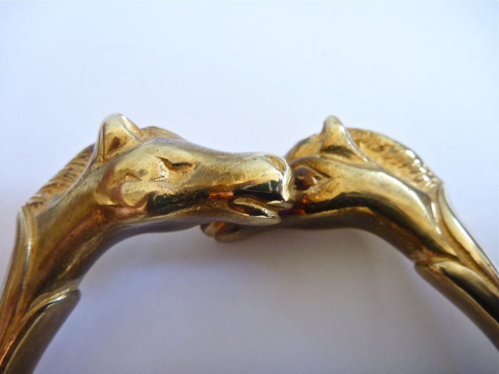 Rare gilt metal double horse head bangle from Hermes. Ca. 1980. Made in France. Very good/excellent condition. I also have the same bracelet with a single horse head for sale.