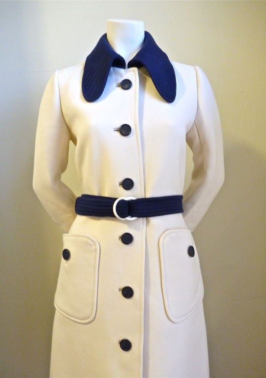 Incredibly rare couture heavy weight winter coat from Courreges. Ca. 1965. Cream wool with navy trim at collar and cuffs with matching belt. Size 'C', best suited for a US 4-6. The measurements are approximately: 38