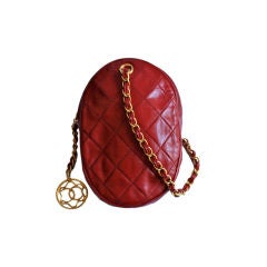 CHANEL red quilited bag with woven chain and large CC charm