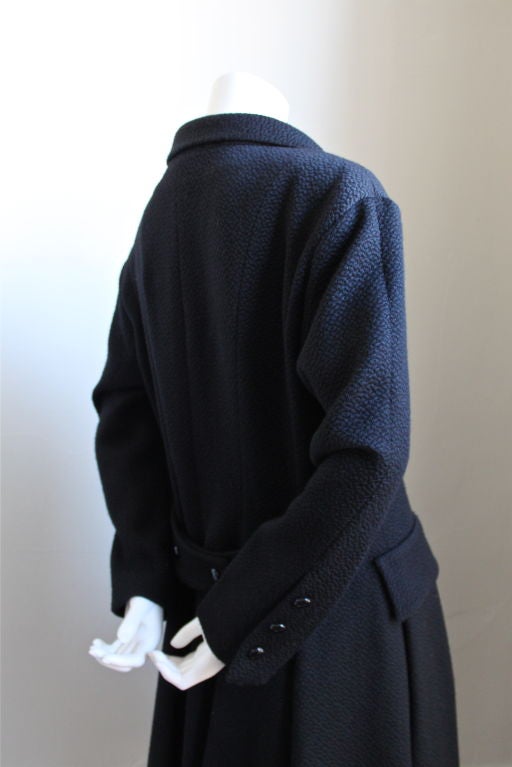 Black textured wool Balenciaga coat specially made for Spanish department store El Corte Ingles (as indicated on label) dating to around 1980. The size is a 42 and bust measures approximately 40