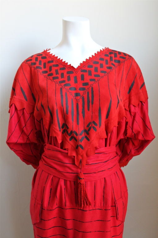 Very rare hand painted silk dress with leather detail from Zandra Rhodes. Ca. 1980. Beautiful details include zig Zag cut edging, a large tassel at front, patch pocket at front hips and matching tie at waist. Very unique hand painting. Best suited