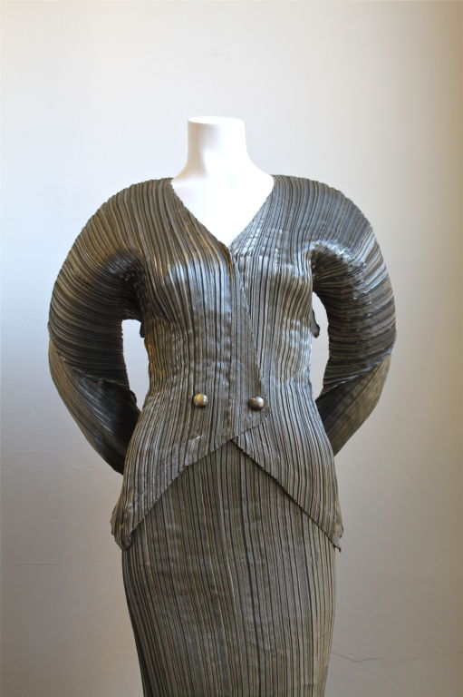Exceptional sculptured and pleated two piece from Issey Miyake dating to the mid-1980's. Metallic bronze in color. <br />
labeled a size 'S', however this set will fit an extra small or medium as well due to the pleating. Miyake skirt