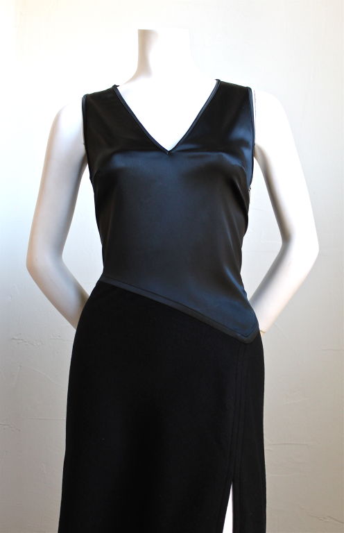 Unique jet black asymmetrical dress from Herve Leger dating to the 1990's. Large slit up front side. Side zip entry. Fully lined. Best suited for a size 6-8. Excellent condition.