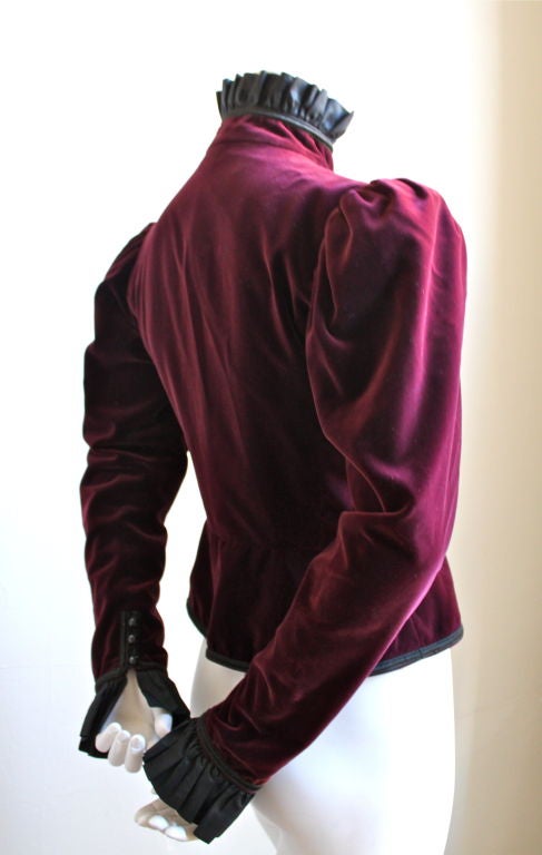 Very rare burgundy velvet 'Russian' jacket with black trim and ruffled taffeta collar from Yves Saint Laurent dating to the 1970's.  Labeled a size 38, this jacket is bets suited for a size 2 or 4. Made in France. Excellent condition.