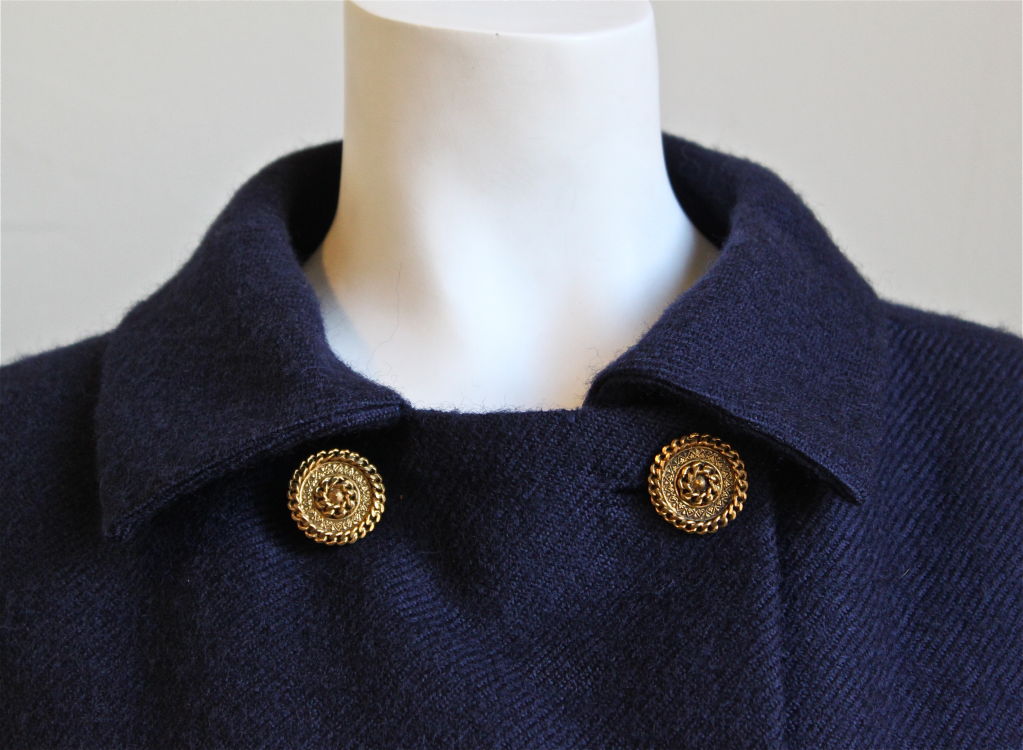 Very rare Balenciaga haute couture cape coat. Ca. 1960. Navy blue wool with gorgeous gilt buttons. Best suited for a US 2 to 6. The attention to detail is everything one would expect from a couture garment. Very clever construction. Fully lined.