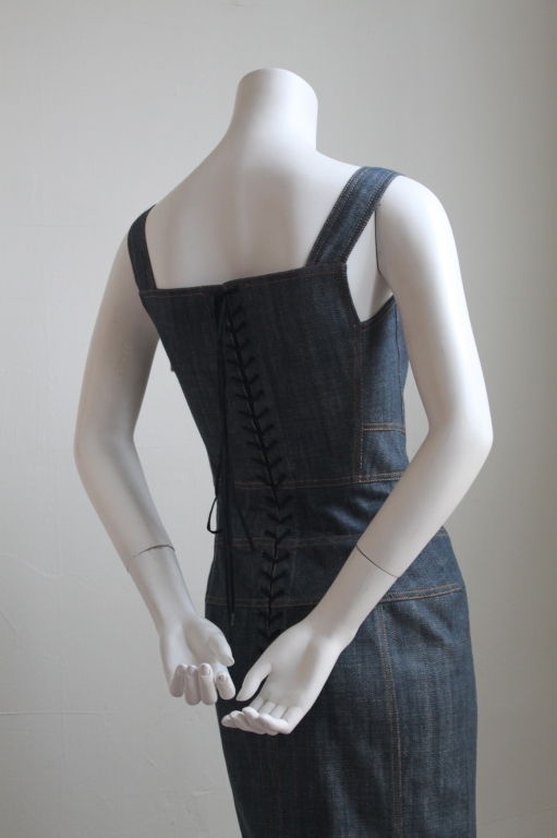 Denim fitted dress with corset lacing at back from Azzedine Alaia. Size 'S'. Fits a US 2. Bust measurements is approximately 32