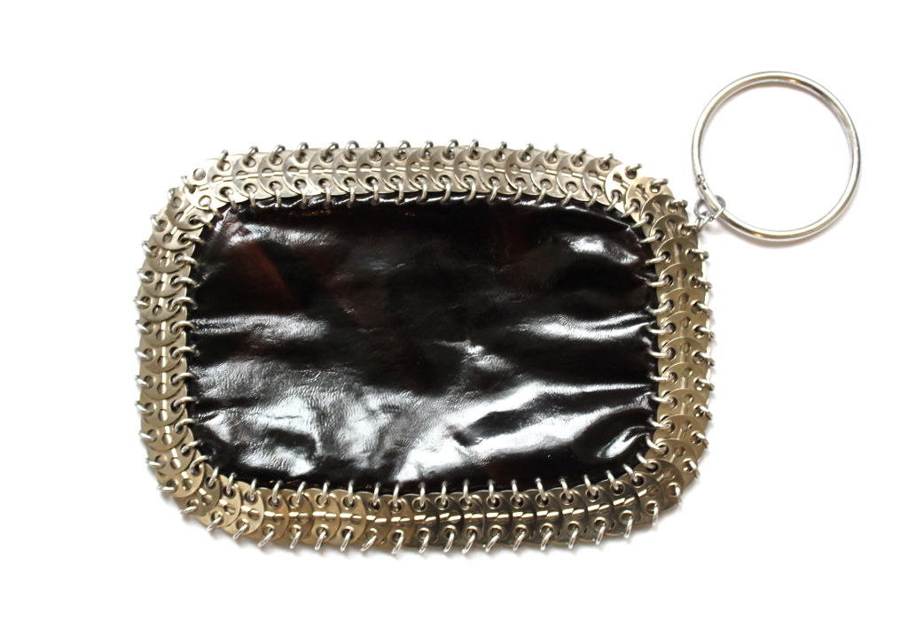 Very rare black patent leather clutch with aluminum hardware from Paco Rabanne. ca. 1965. Zipper entry at front. Measures approximately 9.5
