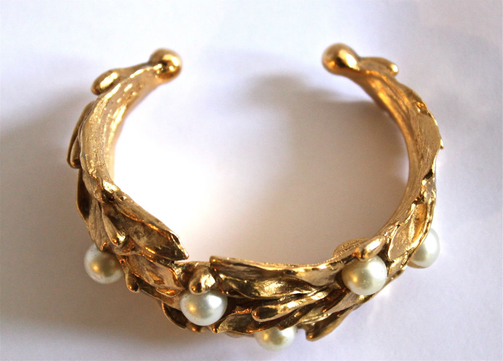 Organically shaped gilt cuff with pearls from Yves Saint Laurent dating to the 1980's. Fits a small/medium wrist. Made in France. Very good condition.