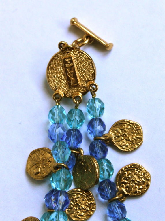 YVES SAINT LAURENT gilt coins and blue faceted bead bracelet In Excellent Condition In San Fransisco, CA