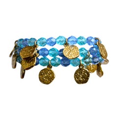 YVES SAINT LAURENT gilt coins and blue faceted bead bracelet