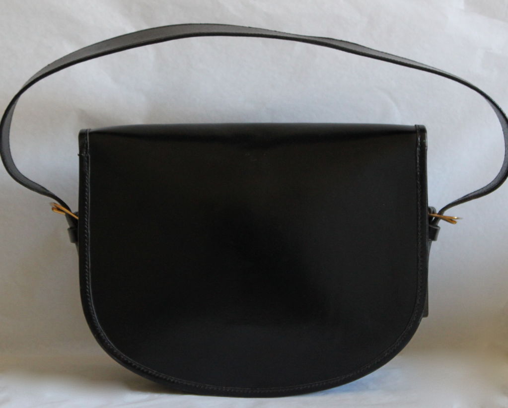 Very rare black box leather bag with gilt hardware from Hermes dating to the 1960's. Numerous compartments. Signed Hermès - Paris - 24 Fg St Honore. Made in France. Phenomenal condition.