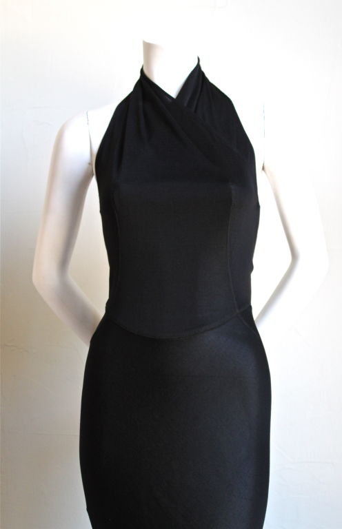 Very rare jet black floor length gown from Alaia dating to the 1990's. Absolutely stunning dress. Labeled a size 'm', although this would best suit a US size 2 or 4. Waist measures approximately 24