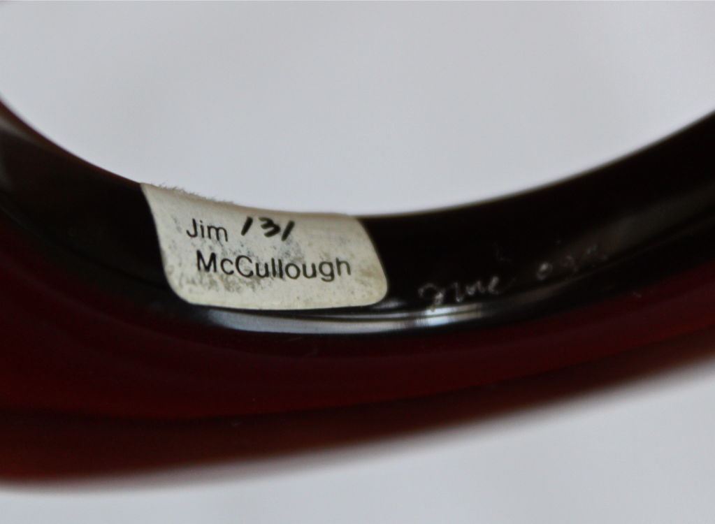 Rich brown lucite bangle made by Jim McCullough. Fits a small wrist. Excellent/unworn condition.