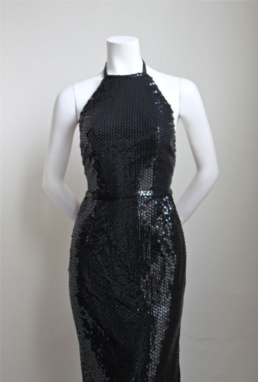 Dramatic jet black halter neck dress covered entirely in flat sequins from Halston dating to the 1970's. Fits a US 2 (24
