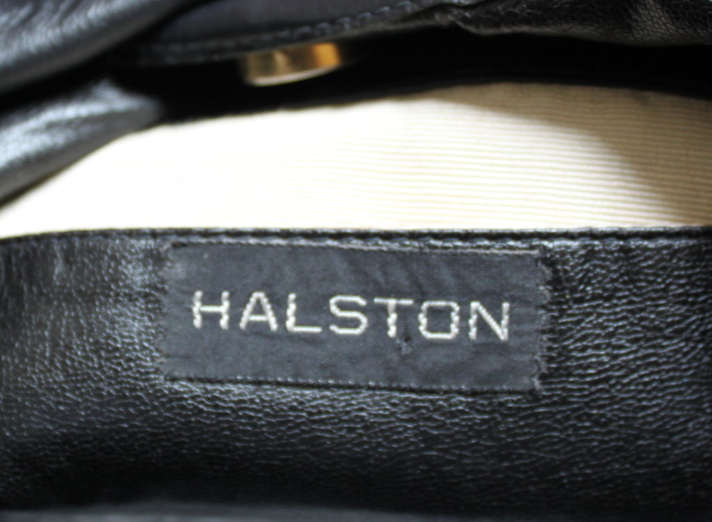 Gorgeous jet black leather bag from Halston with studded belt detail. Fully lined. One interior pocket lined in creme satin. Approximate measurements 12