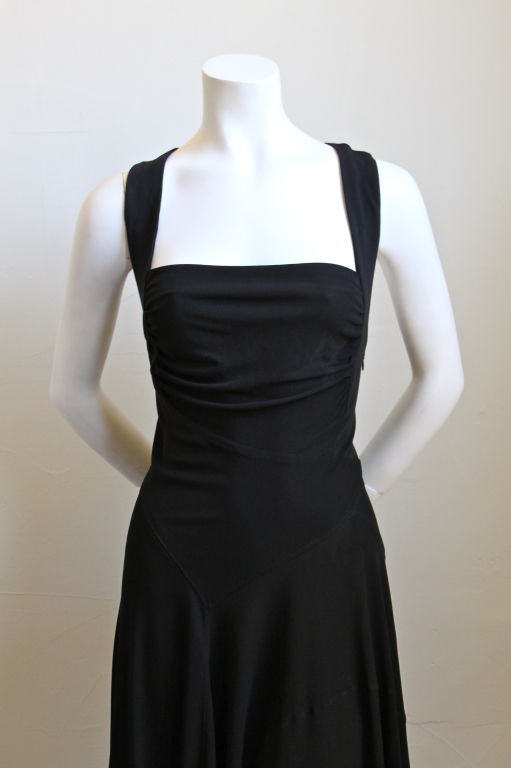 Gorgeous jet black draped jersey dress with asymmetrical seams from Azzedine Alaia. French size 42. Fits a US 8-12. Zips up side. Excellent condition.