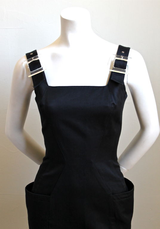 Stunning black structured mini dress with wrap around pockets and clear lucite buckles from Thierry Mugler dating to the 1990's. Fits a US 4 (33