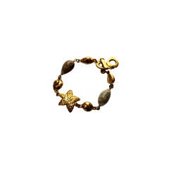 YVES SAINT LAURENT gilt bracelet with sea shells