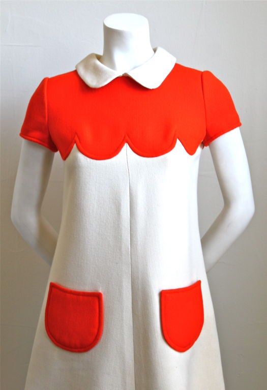 Vivid orange and off white wool haute couture dress from Courreges dating to the 1960's. Labeled a size '0', which fits a US size 2 or 4.  Dress measures approximately 33