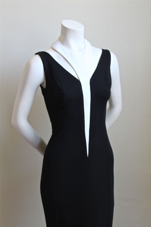 Slinky black jersey dress with unique neckline from Thierry Mugler dating to the early 1990's. Labeled a French size 36, wich fits a US 2 or 4. Dress measures approximately 32