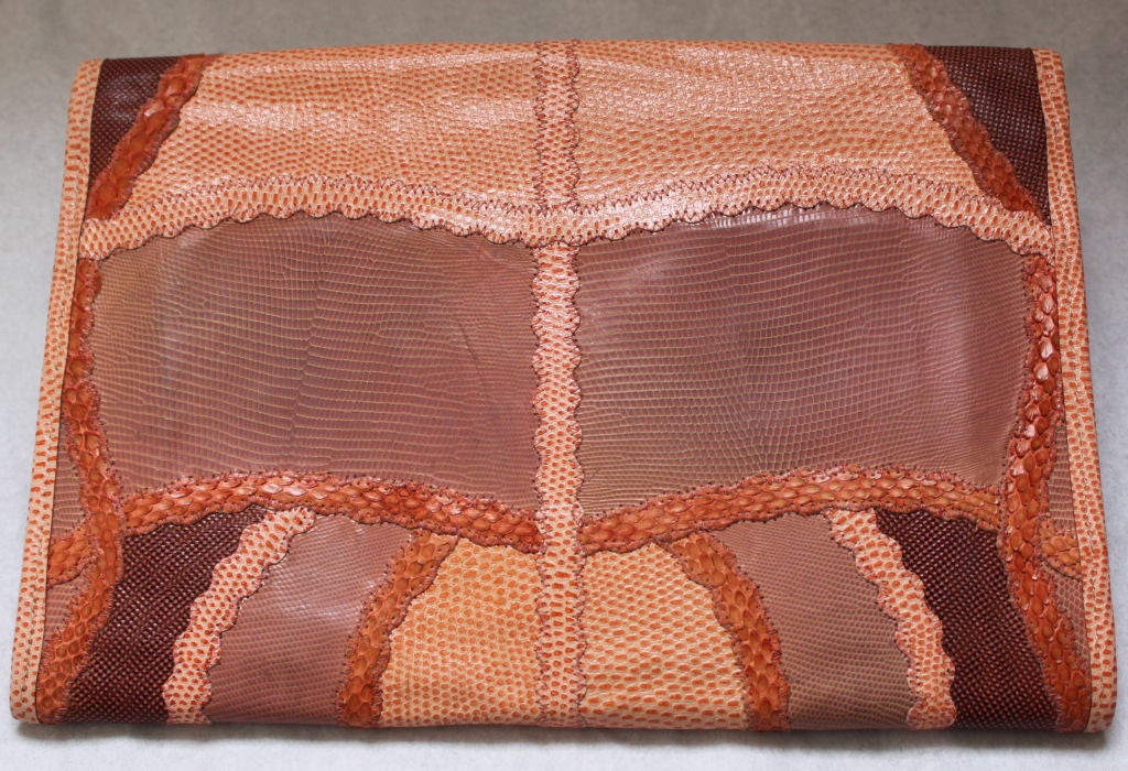 Beautiful peach patchwork clutch made of reptile skins from Carlos Falchi. Bag measures approximately 12