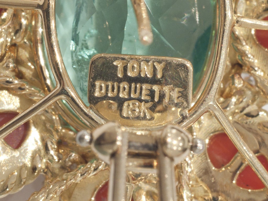 18 k gold earclips, centering oval fluorite, surrounded by coral cabochons and and diamonds. For pierced and non-pierced ears. Signed, TONY DUQUETTE 18K.
