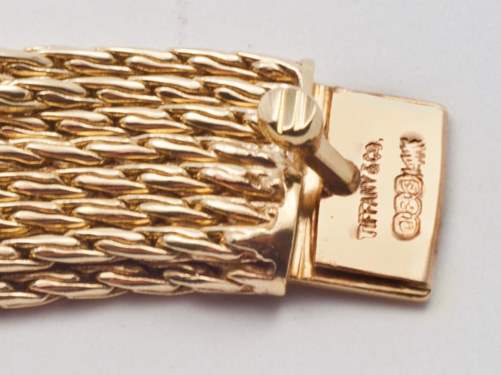 14kt gold bracelet consisting of multiple fishtail chains secured by diamond and gold 