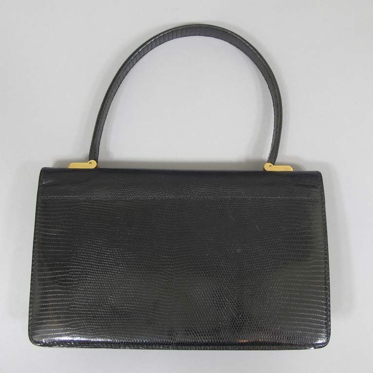 Lederer envelope bag with a deco round push-in closure lined in leather.  Made in France. Strap is sturdy and attached with art deco type gold bindings.  1965.