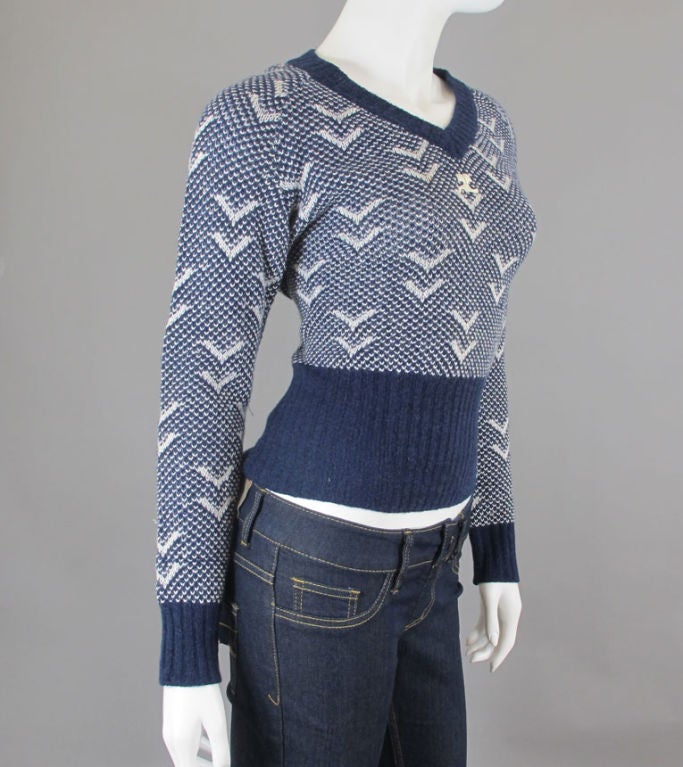 Midnight blue and white nautical theme semi-open knit sweater. On the right sleeve there is a slight cuff above cuff. Wide ribbing on bottom, ribbed cuffs and neckline. Courreges emblem under the V.  There are a few thread pulls on the sleeve.<br