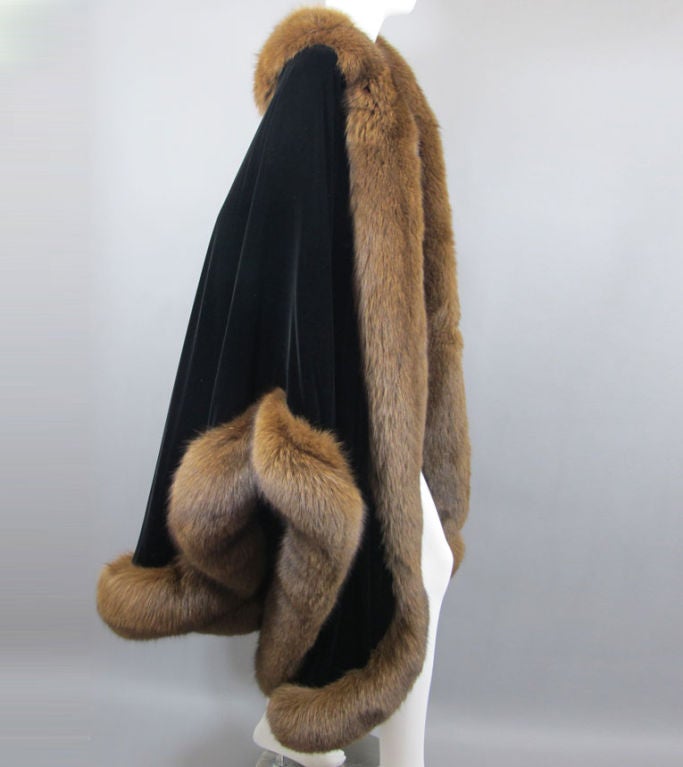 A once in a life time opportunity to own a rare Halston masterpiece. An extraordinary cape made exclusively for famous dancer and Halston muse Martha Graham.  Very rare made in the 1980's. A black velvet cape trimmed with real fox fur. Draped