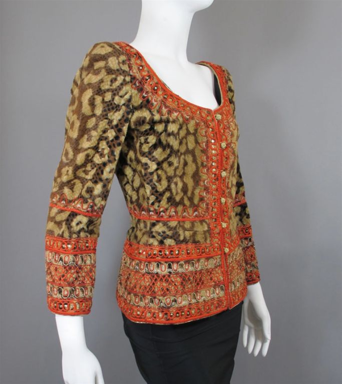 From Mary McFadden Couture comes this gorgeous leopard print faux fur jacket with red and gold embroidered and beaded trim.  This one-of-a-kind jacket - which has the texture of fur -  is an elegant natural brown leopard print trimmed in gold lame,