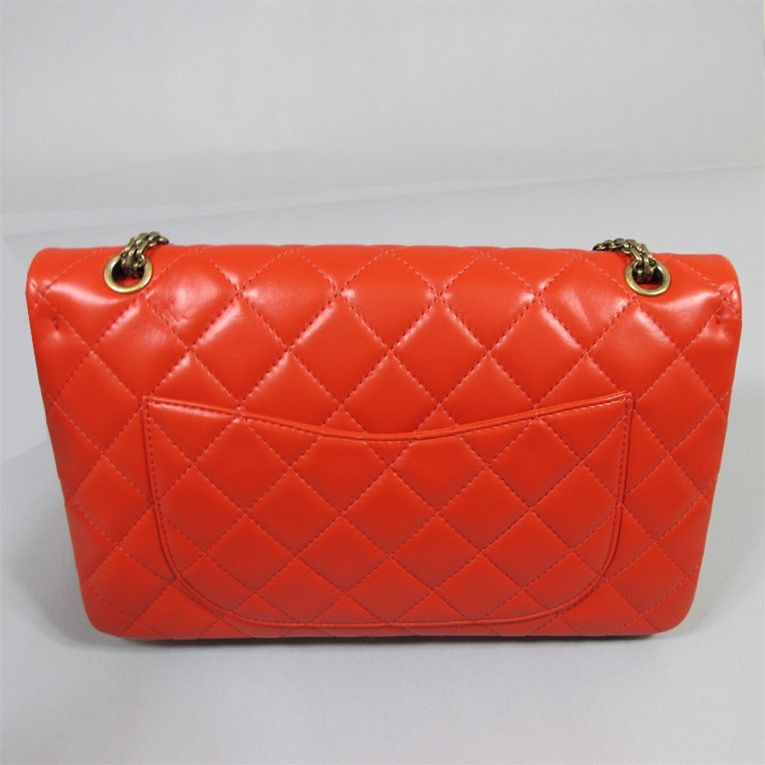 Chanel jumbo reissue 2.55 in red lambskin. This classic double flap quilted handbag features gold tone hardware with front Chanel mademoiselle turn-lock closure. The red color is hard to find. Bag features 3 separate compartments, envelope back