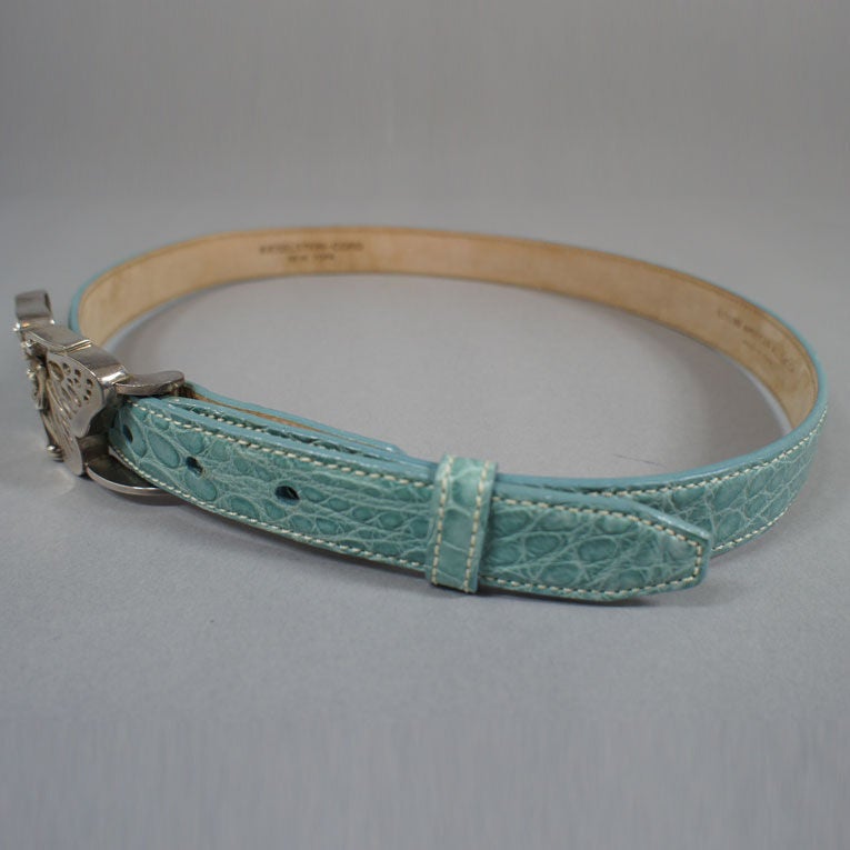 Kieselstein-Cord pale seafoam color alligator skin belt with sterling silver metal angelic butterfly buckle closure. Adds a beautiful aqua pop of color to any dark ensemble. Buckle 