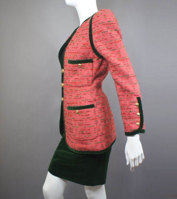 Chanel season perfect vintage skirt suit comprising a pink tweed (of shades of pink and green with white) boucle trimmed in green velvet jacket and matching green velvet skirt.  The jacket has a round neckline extending down the front with three