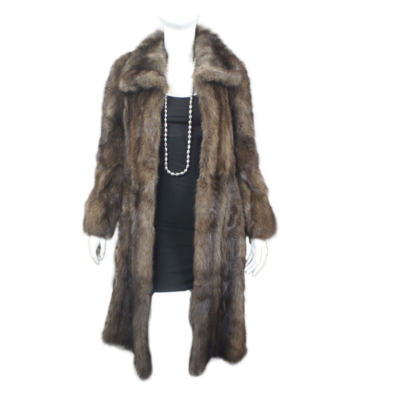 Sobol extra silver Russian sable coat from Saks Fifth Avenue, the Fur Salon. Natural color, wing collar, set in bell sleeves. Hidden hook and eye closures. Appraised at $136,500 (Saks). We are told each pelt is individual numbered. This Sobol coat