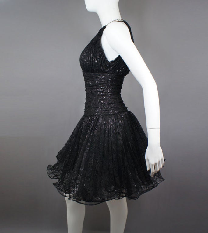 Vicky Tiel Couture exquisite black cocktail dress. Floral lace composition with intertwined with sleek dark silver thread accents, and fitted torso for an hour glass silhouette. Full ballerina skirt with black tulle under-layers. The six-row